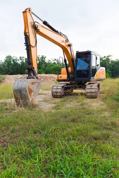 Yellow construction transport excavator digging earth outdoors