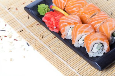 Ahşap bir arka plan üzerinde taze somon suşi rulo