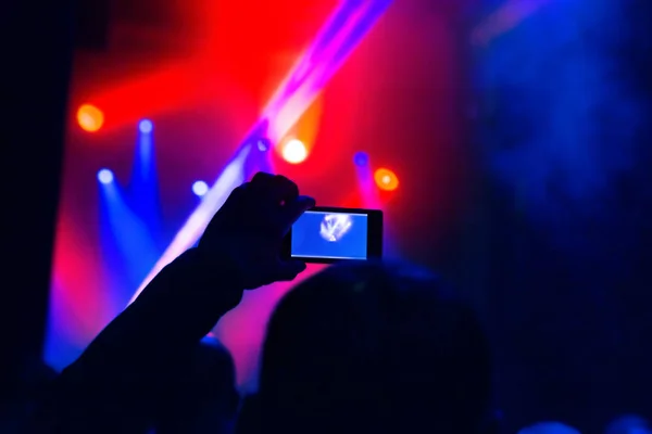 Hombre tomando foto video por teléfono móvil de siluetas multitud fiesta concierto música — Foto de Stock