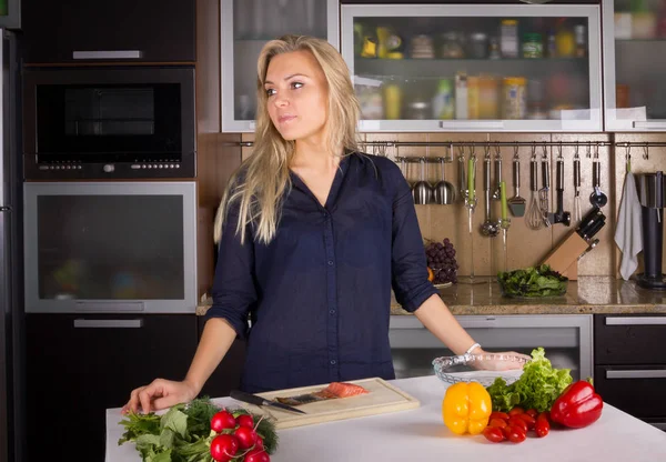 Giovane bella giovane donna che cucina insalata in cucina — Foto Stock