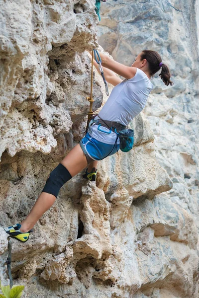 Young woman rock climbing on karst limestone white mountain in Thailand — 스톡 사진