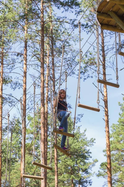 Jonge dappere vrouw klimmen in een touw avonturenpark — Stockfoto