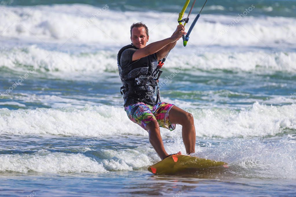 Wan riding kite surf on sea waves