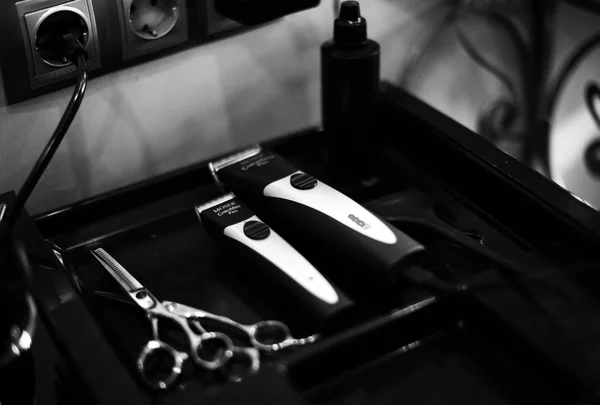 tools for haircuts. clipper and shaving machine, scissors, hairdryer, spray. beauty saloon