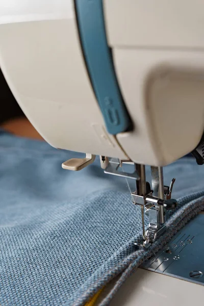 缝纫机用蓝色织物缝制装饰性绳子的过程. — 图库照片