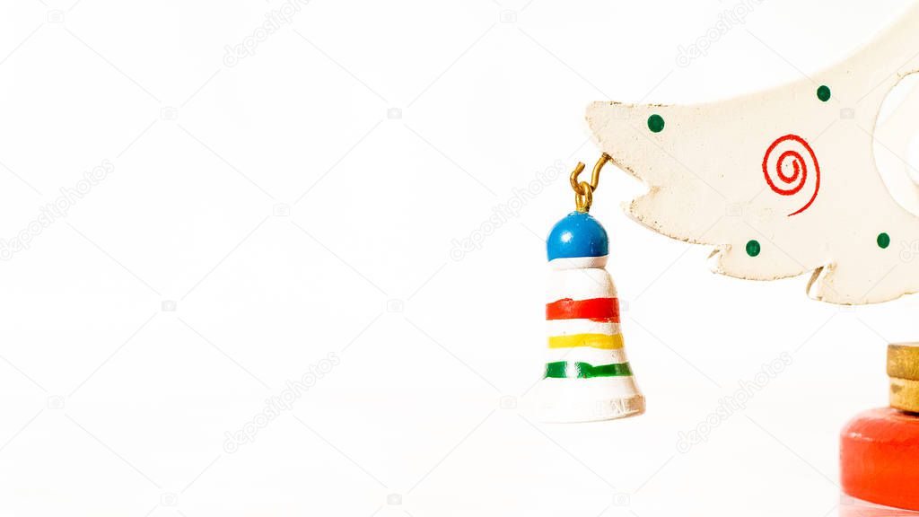 Christmas white ticket decorated with a wooden gift hanging on a branch of a wooden toy Christmas tree