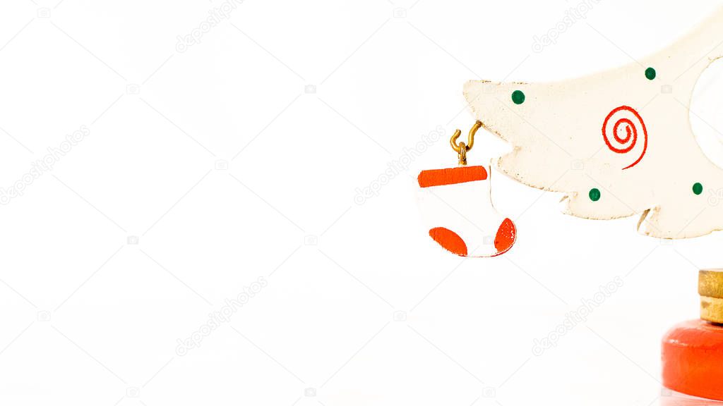 Christmas white ticket decorated with a wooden white glove hanging on a branch of a wooden toy Christmas tree