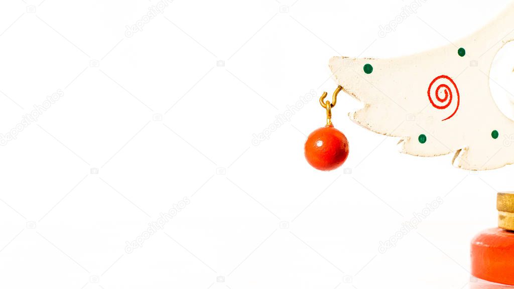 Christmas white ticket decorated with a wooden red ball hanging on a branch of a wooden toy Christmas tree