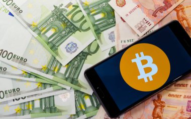 Euro para arka planda bir bitcoin logosu ile Telefon