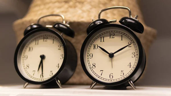 black desk clock on the shelf