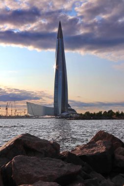 Körfezde büyük granit taşları parlayan modern gökdelen.