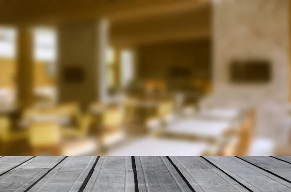 Wood table top and Blur restaurant - vintage effect style picture. can be use for display or montage your products.