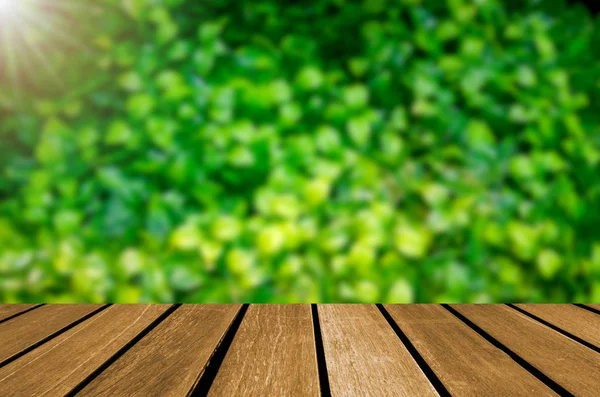 Tom träbord oskärpa grönt blad — Stockfoto