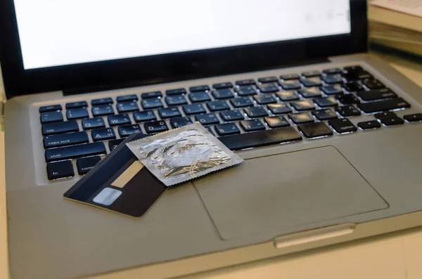 Condom on laptop — Stock Photo, Image