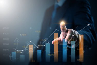Businessman analyzing financial data on digital screen with growth chart. Great for business analytics, financial forecasting, investment growth, and market strategy visuals.
