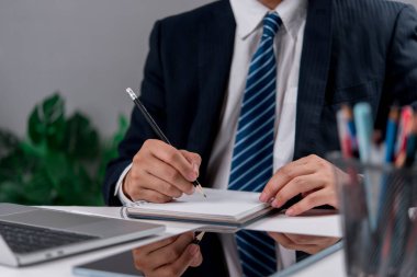 Close-up of manager preparing strategy in office notebook. Great for topics like corporate planning, business work, project development, and productivity.