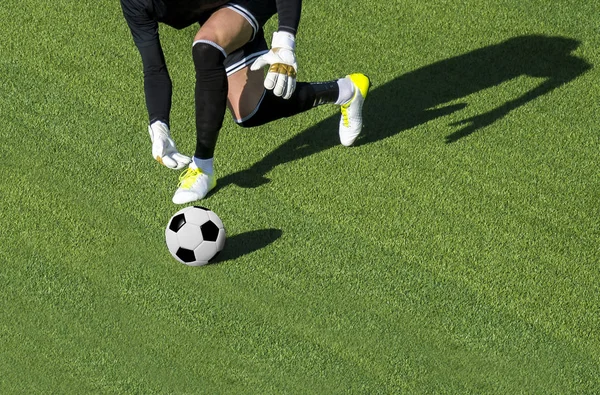 man goalkeeper about to throw a football in field