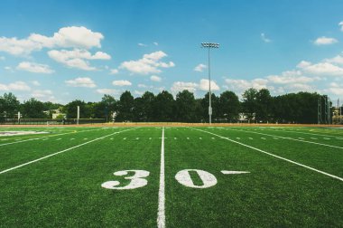 30 Yard Line on American Football Field and blue sky clipart