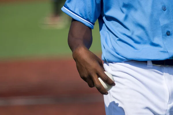 Baseball pitcher holding baseball about to throw the ball