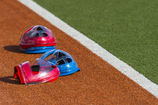 Field hockey equipment on green grass