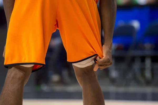 Orange shorts basketball player. Team sport