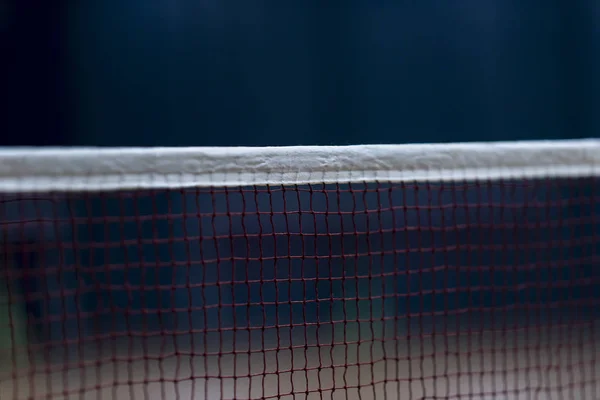 Badminton net indoor on badminton court, closeup view of badminton net with blurry background
