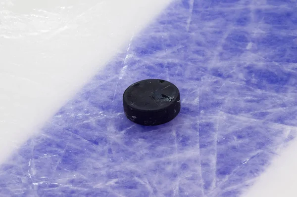 Puck on ice hockey rink surface, sport background