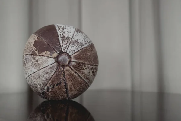 old medicine weight ball on wooden floor