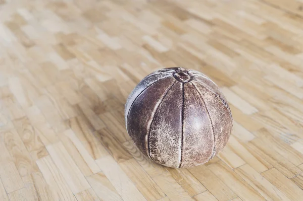 old medicine weight ball on wooden floor