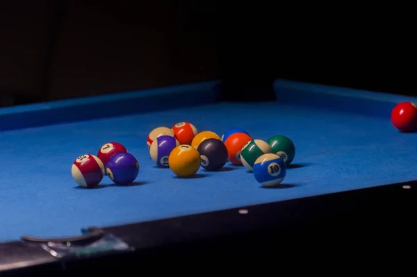 Colorful billiards balls. Billiard ball at blue table. Colorful American pool snooker balls background. American Billiard in bar. Close up Billiard balls. Bar game. Billiard table game.