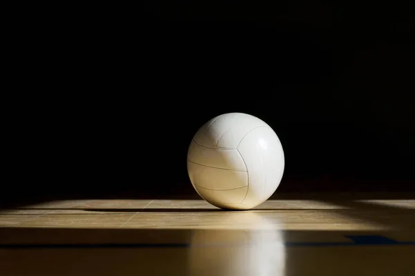 Volleyball court wooden floor with ball isolated on black with copy-space