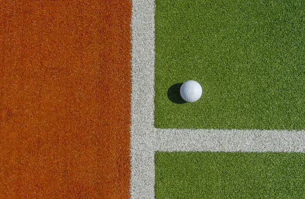 White dimple hockey ball on astro turf