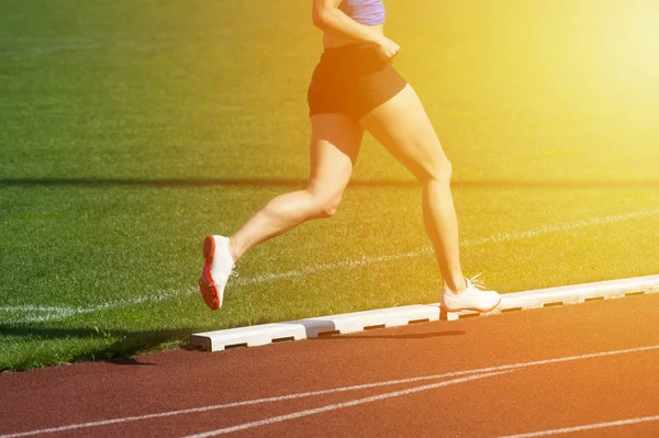 Athletics woman running on the track field — Stock Photo, Image