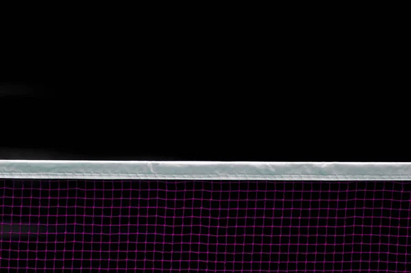 Badminton net indoor on badminton court, closeup view of badminton net with black background