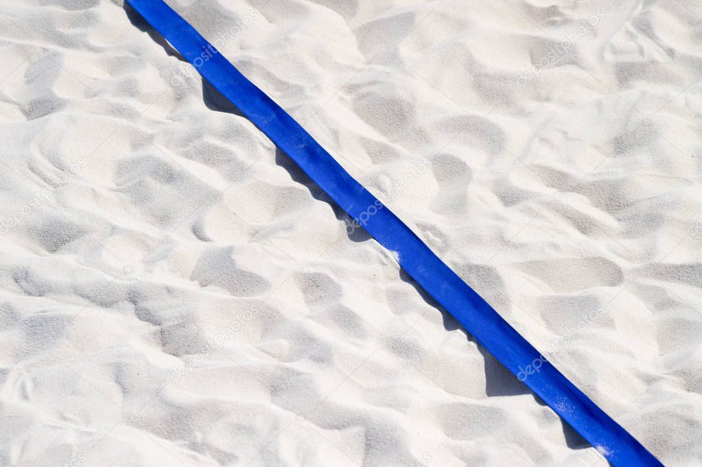 beach volleyball, soccer, handball court up close and in detail with blue plastic line marker