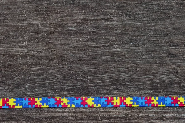 World Autism awareness and pride day with Puzzle pattern ribbon