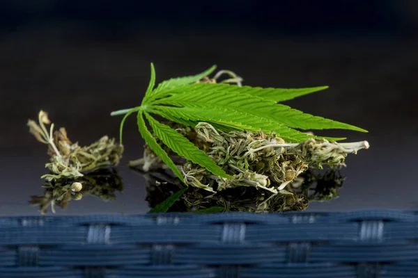 Cannabis herbal tea and marijuana leaves.