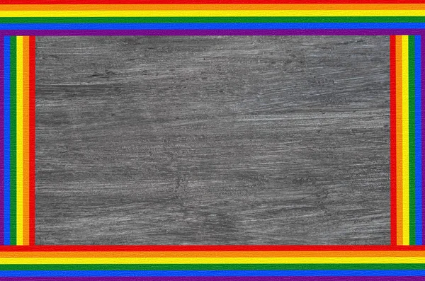 LGBT rainbow flag text frame banner isolated on gray wooden background