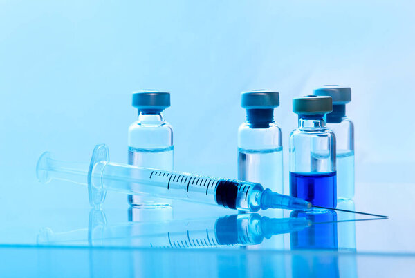 Close-up medical syringe with a vaccine. Vaccination and healtcare concept.