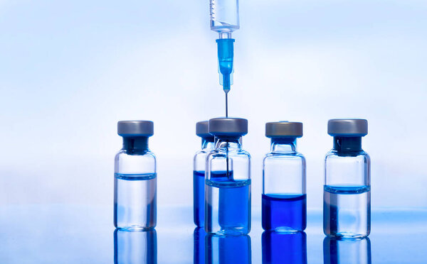 Close-up medical syringe with a vaccine. Vaccination and healtcare concept.