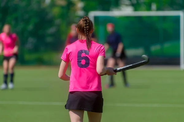 A beautiful young woman field hockey player