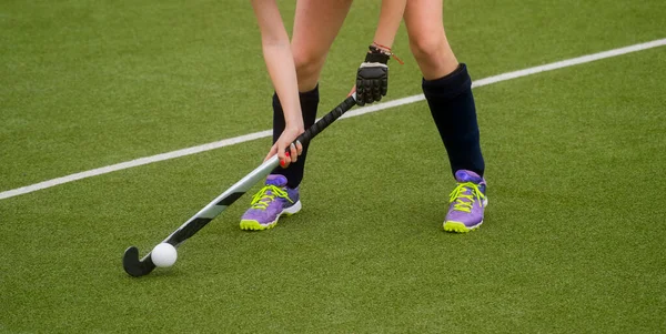 Field Hockey player, ready to pass the ball to a team mate. Hockey is a team game