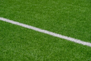 Yeşil sentetik çim spor sahası, yukarıdan beyaz çizgili. Futbol, ragbi, futbol, beyzbol sporu konsepti.