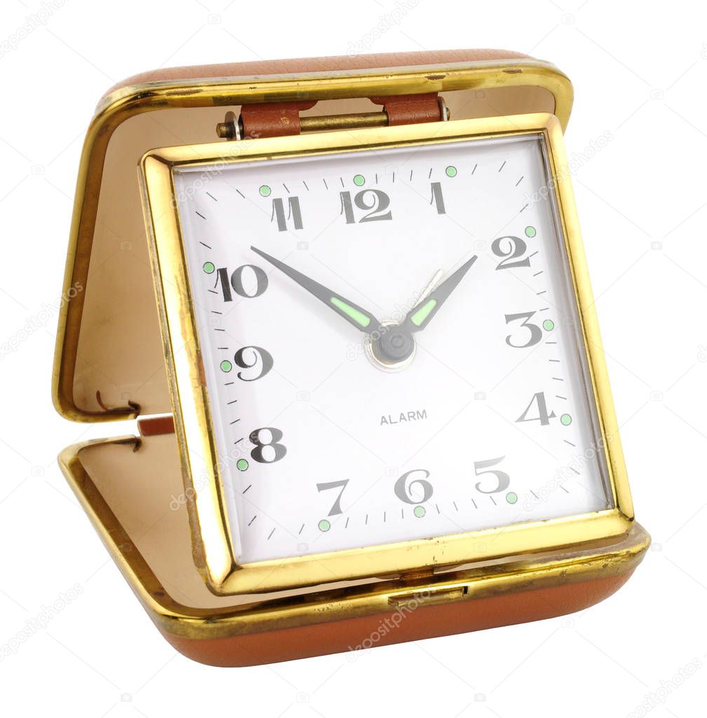 Old retro travel alarm clock isolated on a white background