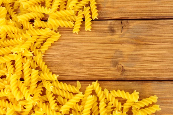 Uncooked Dried Eliche Pasta Spirals Wood Background — Stock Photo, Image