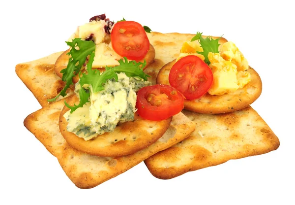 Savoury cheese biscuits and cheese assortment isolated on a white background