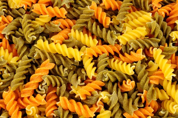 Uncooked Tricolore Fusilli Pasta Twist Shapes Background — Stock Photo, Image