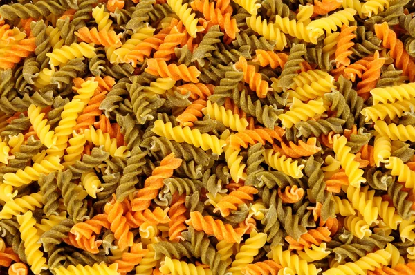 Uncooked Tricolore Fusilli Pasta Twist Shapes Background — Stock Photo, Image