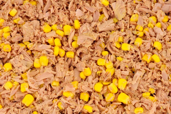 Flaked tuna fish and sweet corn background