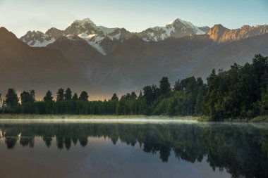 Lake Matheson. Locate near the Fox Glacier in West Coast of South Island of New Zealand. It is famous for its reflected views of Aoraki/Mount Cook and Mount Tasman. clipart